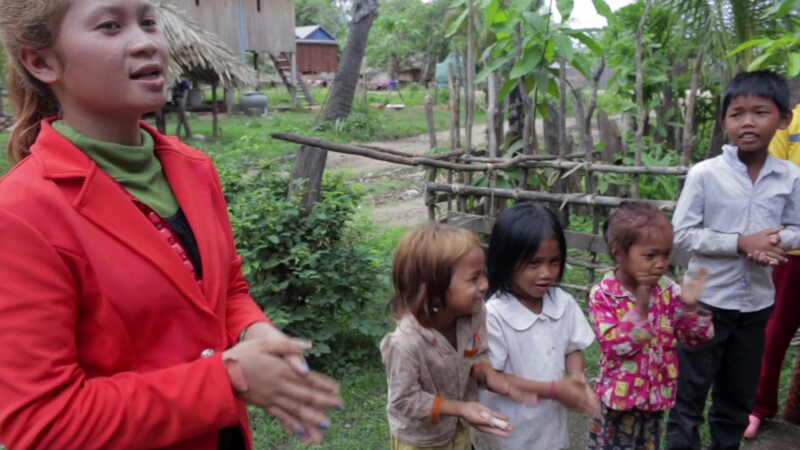 Learning About Health — An ADRA Health worker teaches children principles of Good health through games and song. — Asia, Cambodia, health, health worker, ADRA