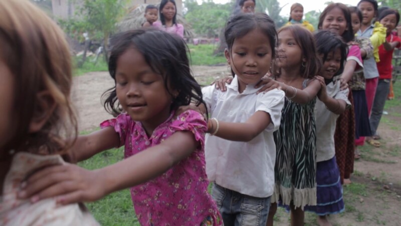 Learning About Health — An ADRA Health worker teaches children principles of Good health through games and song. — Asia, Cambodia, health, health worker, ADRA
