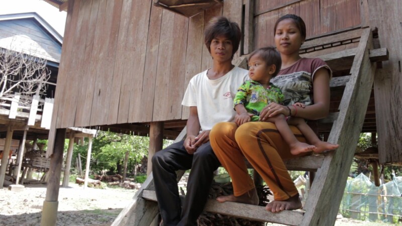 Sitting on the Steps — Stock Video Footage of Cambodia: Young couple with their baby, sit on the front steps of their home in a remote village in Preah Vihea...