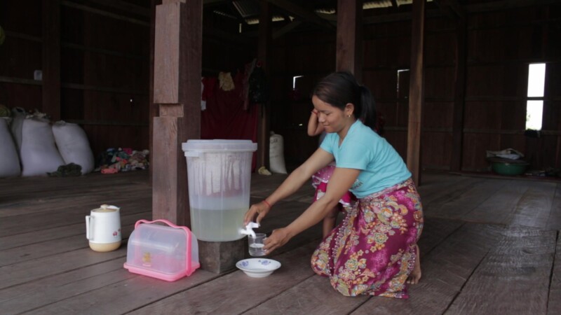 Filtered Water — Stock Video Footage of Cambodia: Young mother gets her baby a drink from a water filtration system — Asia, Cambodia, Preah Vihear Province, ...