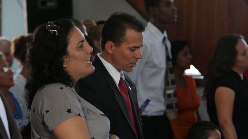 Couple Sing Hymns in Church in Cuba — Stock Video Footage of Christianity in Cuba: Cuban couple sing songs at an Adventist Christian Church service in Santia...