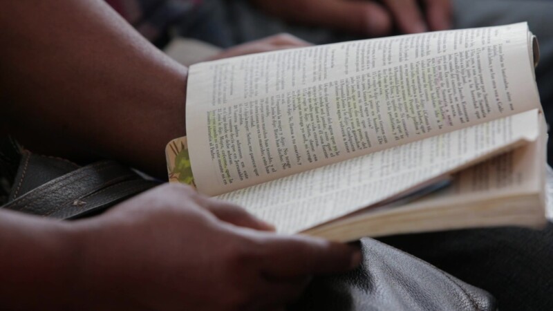 Reading Bible in Church in Cuba — Closeup of someone reading a small Bible at a Christian Church service in Santiago de Cuba. — Adventist, Adventists, Christ...