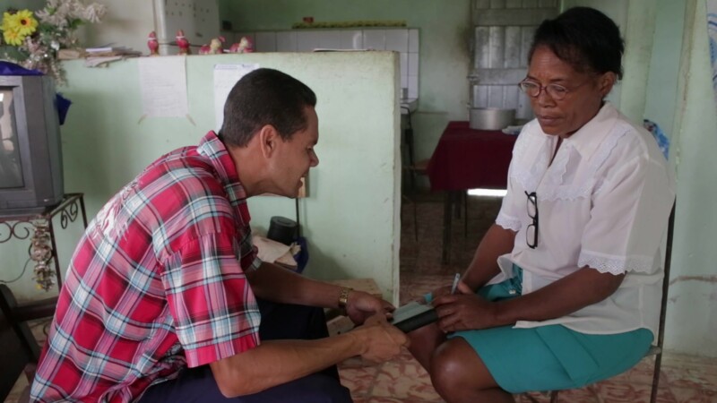 Prayer in Cuba — Stock Video Footage of Christianity in Cuba: Adventist Lay Pastor meets with a church member in her home and they have prayer together. — Ad...