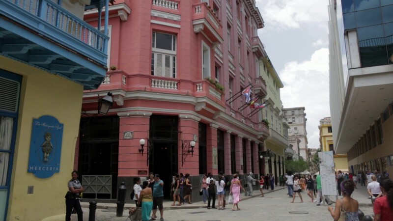 Old City Street of Havana — Pan down of buildings in the old city of Havana to a narrow street of tourists walking. — Cuba, Havana, Habana, Historical, Colonial