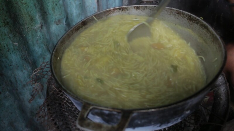 Cooking Food in Dominican Republic — Stock Video Footage of the Dominican Republic: Woman, living in a poor community, cooks a simple meal for her family. — ...