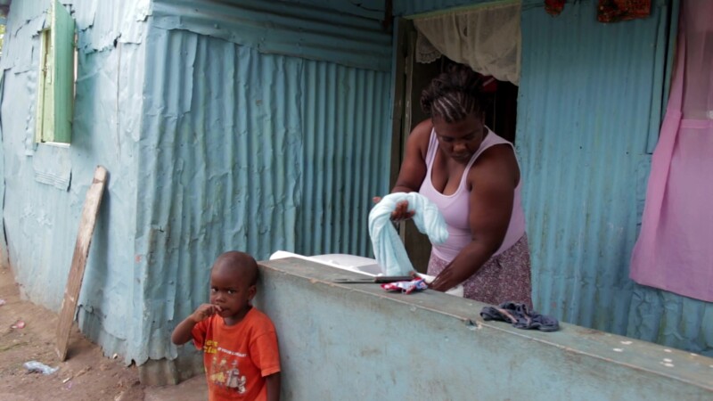 Doing the Laundry — Stock Video Footage of the Dominican Republic: Woman living in a poor community in rural Dominican Republic does the family wash. — Carib...