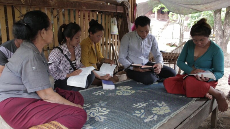 Bible Study in Laos — People study the Bible together at a home church in a remote village in Laos. — Asia, Laos, Home Church, Christianity, Bible