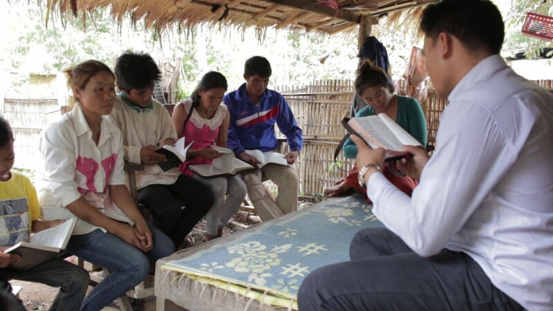 Bible Study in Laos — People study the Bible together at a home church in a remote village in Laos.