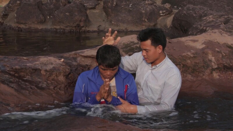 Baptism in Nature — Stock Video Footage of Laos: Young man joins the Christian faith through baptism in a mountain stream that runs by his village in a remot...
