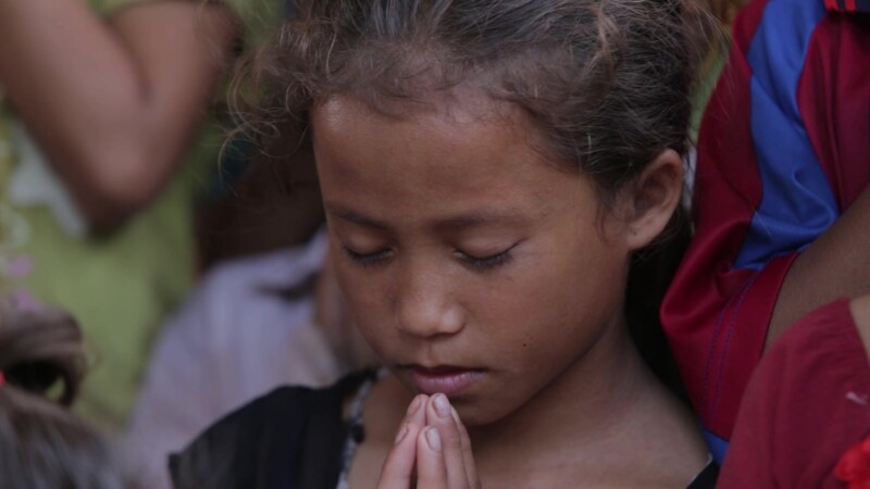 A Child's Prayer — Stock Video Footage of Laos: Young Lao girl prays, at a Christian group meeting for children, in a rural region of Communist Laos. — Asia,...