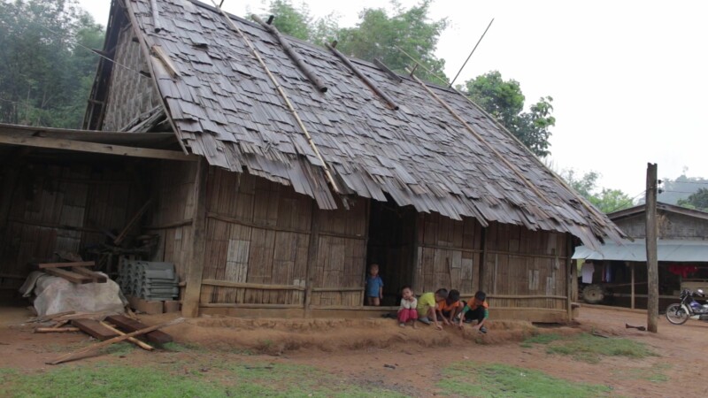 Hmong Village Home — Stock Video Footage of Laos: Group of Hmong Children, sitting outside a typical home in a Hmong village in remote Laos. — Asia, Laos, Hm...