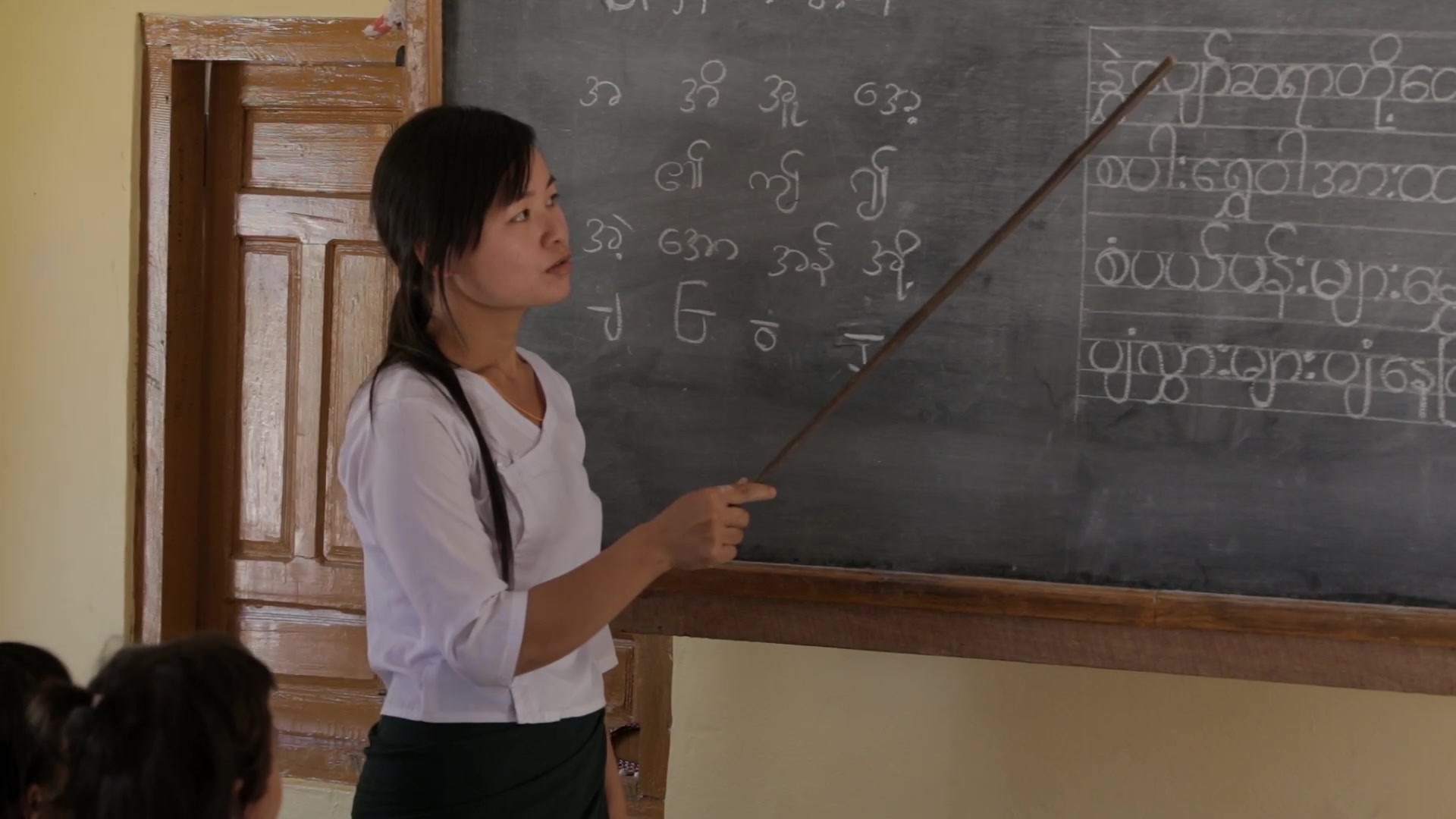 Teacher presents Lesson from the Board