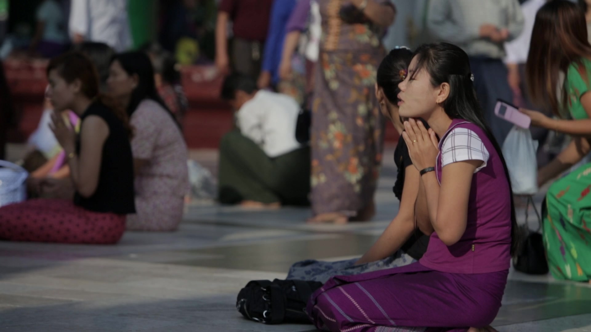 Woman Praying at a Buddhist Pagoda in Myanmar