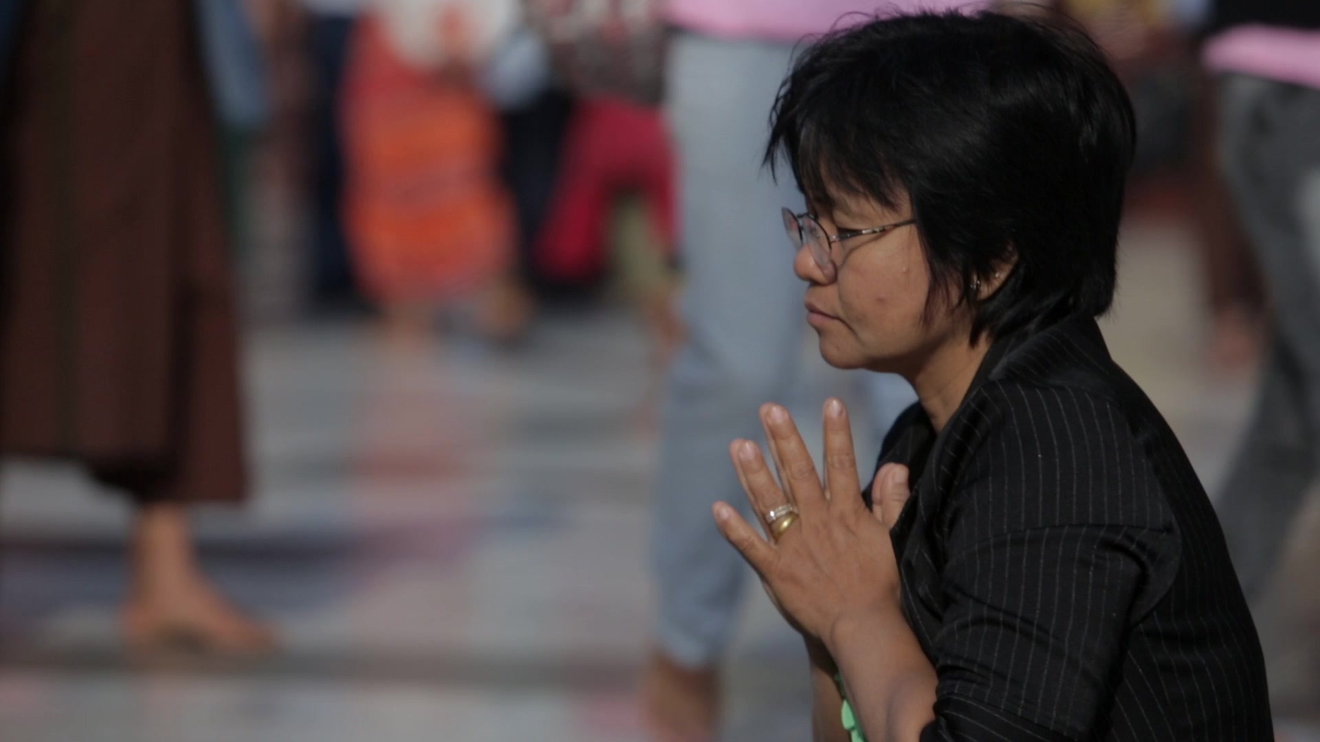 Woman Praying at a Buddhist Pagoda in Myanmar