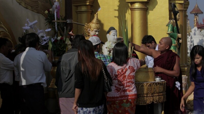 People Worshiping at a Pagoda in Myanmar — People follow the traditional and cultural practices of a typical visit to a Buddhist Pagoda in MyanmarKeywords: B...