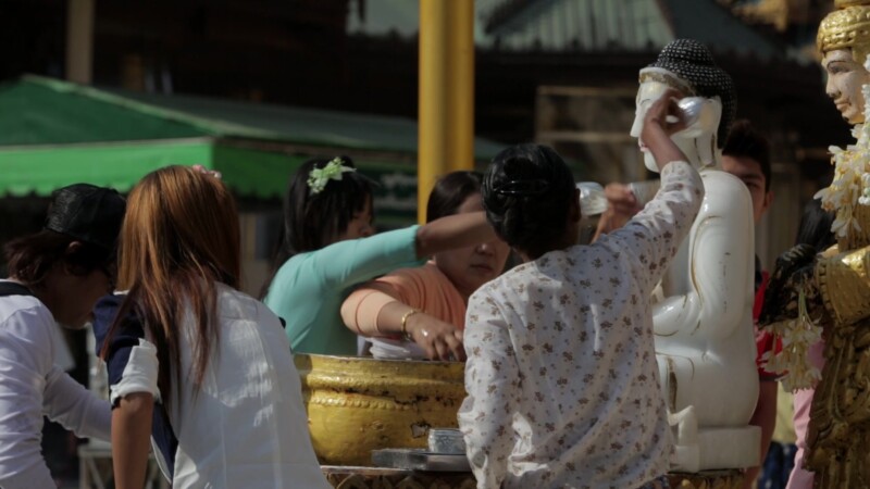 People Worshiping at a Pagoda in Myanmar — People follow the traditional and cultural practices of a typical visit to a Buddhist Pagoda in MyanmarKeywords: B...