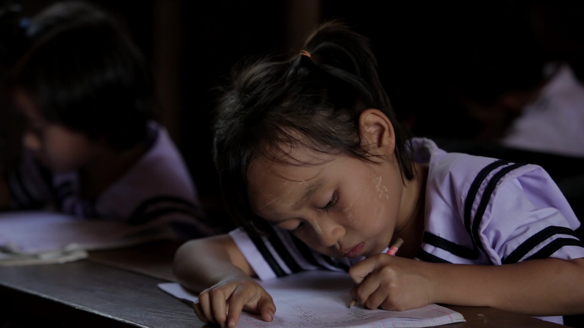 Karen Student Writes at their Desk
