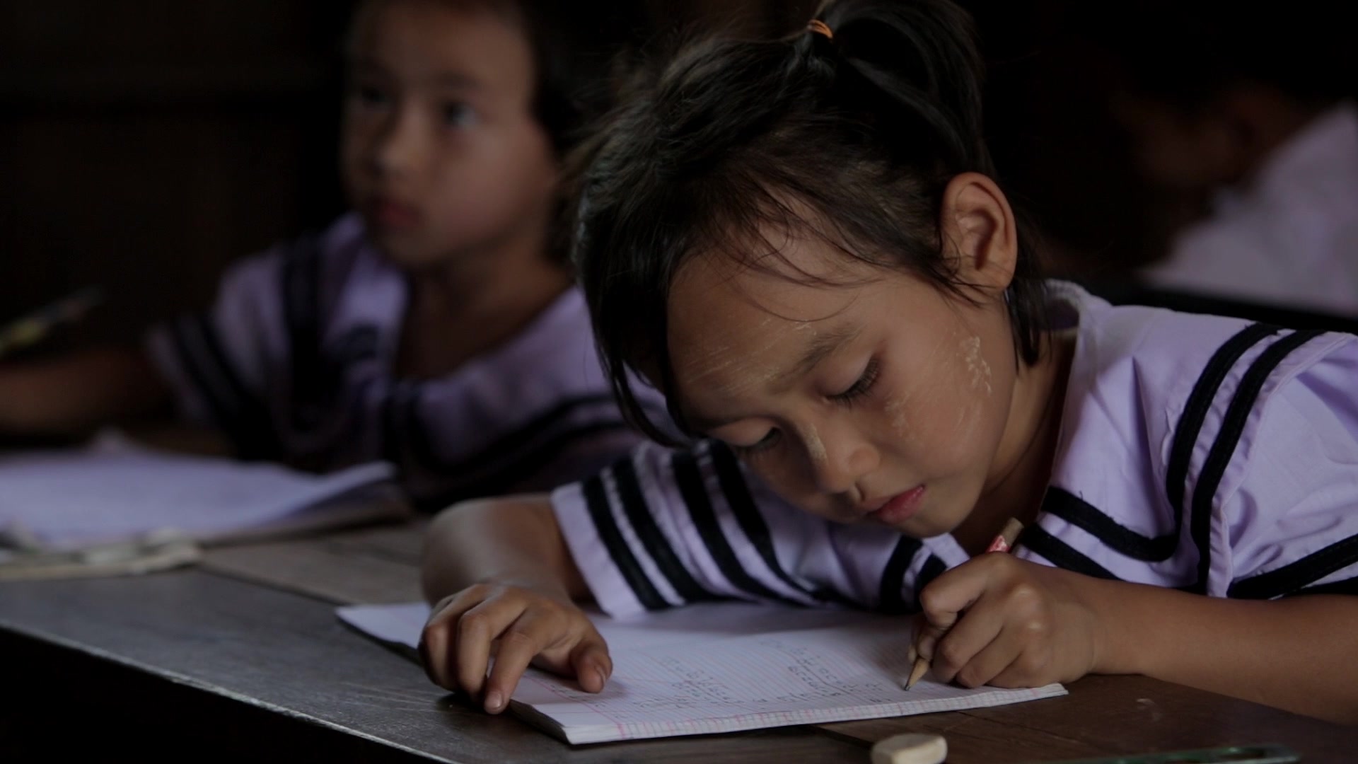 Karen Student Writes at their Desk