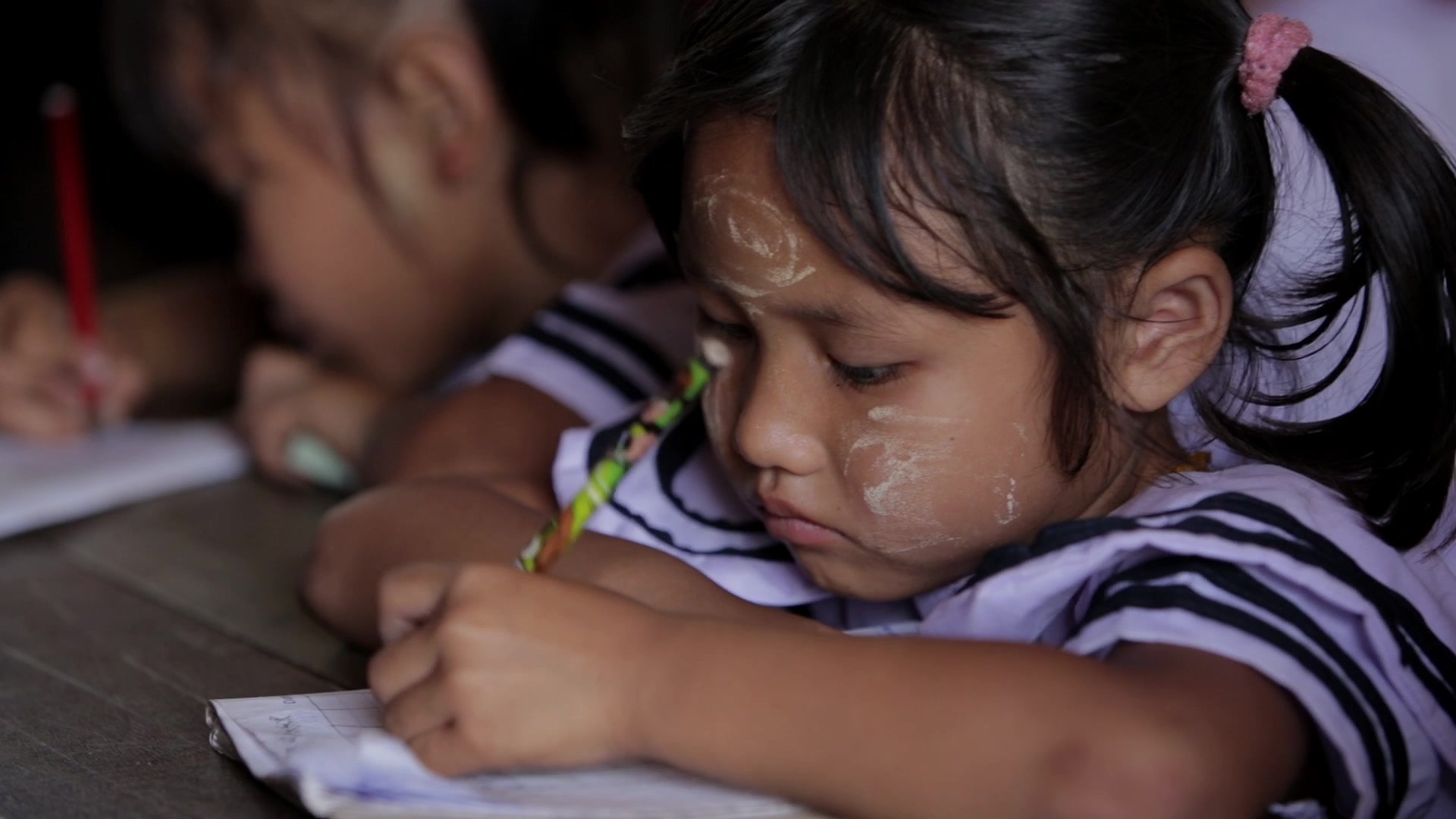 Karen Student Writes at their Desk
