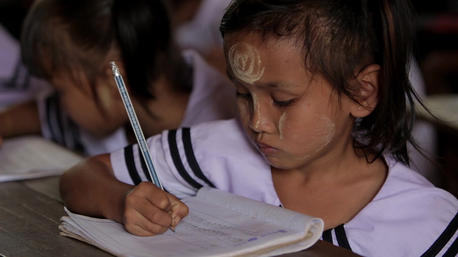 Karen Student Writes at their Desk