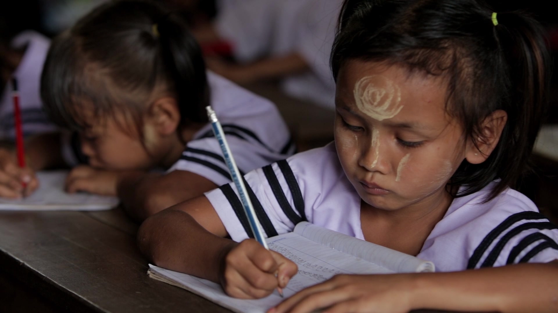 Karen Student Writes at their Desk