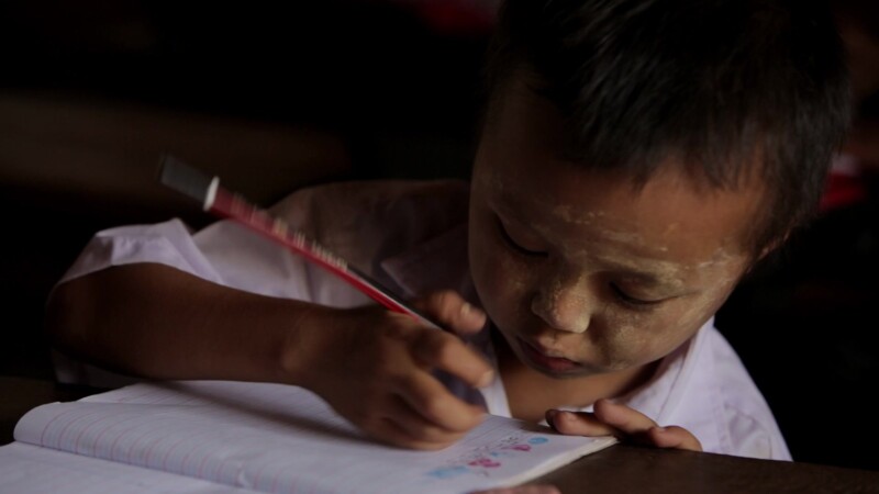 Karen Student Writes at their Desk — Student of the Karen Ethnic goroup Writes at their Desk at their school in MyanmarKeywords: Burma, Child, Children, Kare...