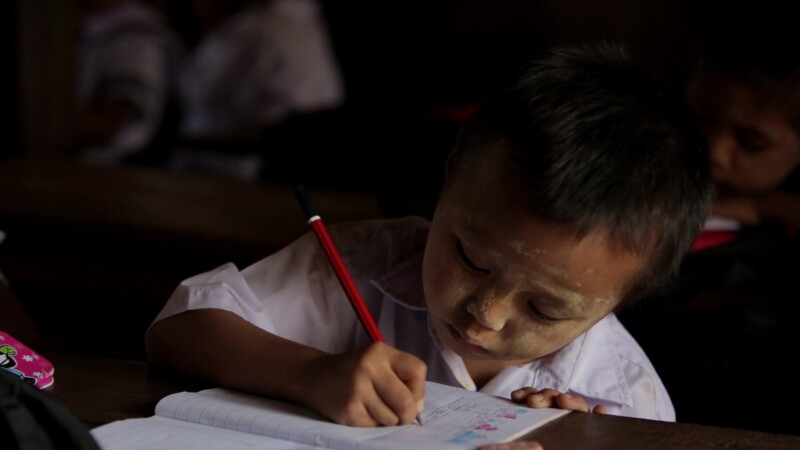 Karen Student Writes at their Desk — Student of the Karen Ethnic goroup Writes at their Desk at their school in MyanmarKeywords: Burma, Child, Children, Kare...