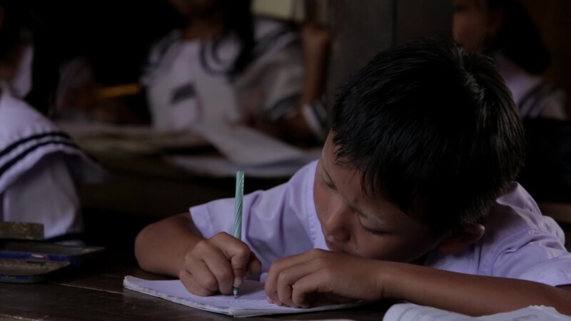 Karen Student Writes at their Desk — Student of the Karen Ethnic goroup Writes at their Desk at their school in MyanmarKeywords: Burma, Child, Children, Kare...