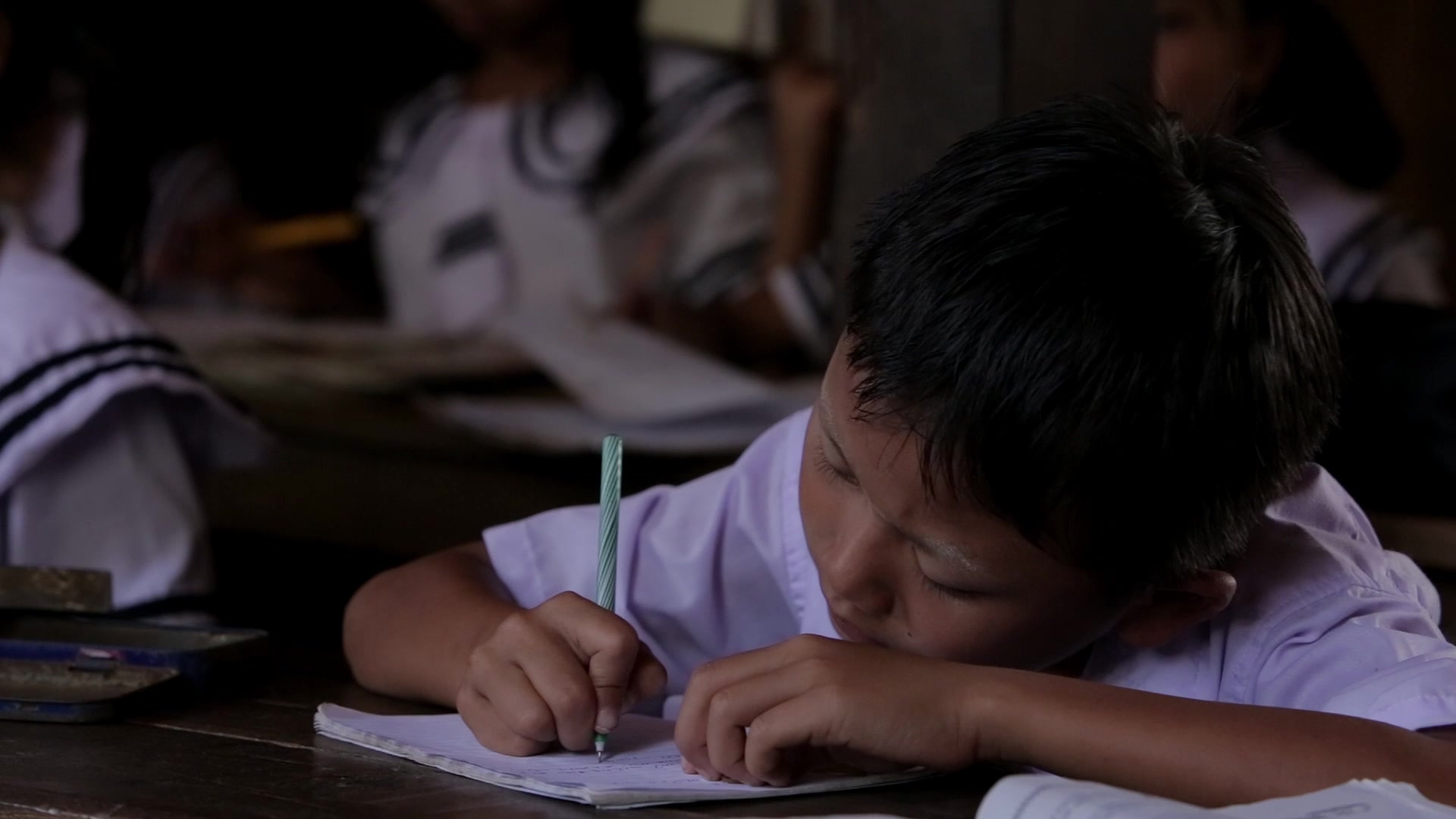 Karen Student Writes at their Desk