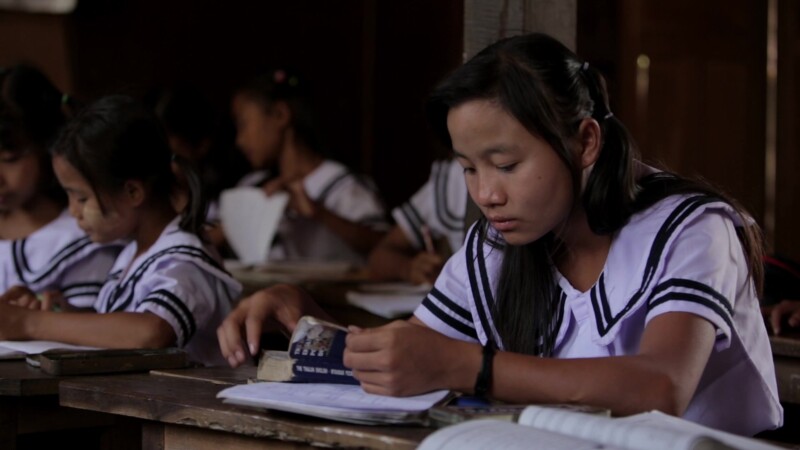 Karen Student Writes at their Desk — Student of the Karen Ethnic goroup Writes at their Desk at their school in MyanmarKeywords: Burma, Child, Children, Kare...