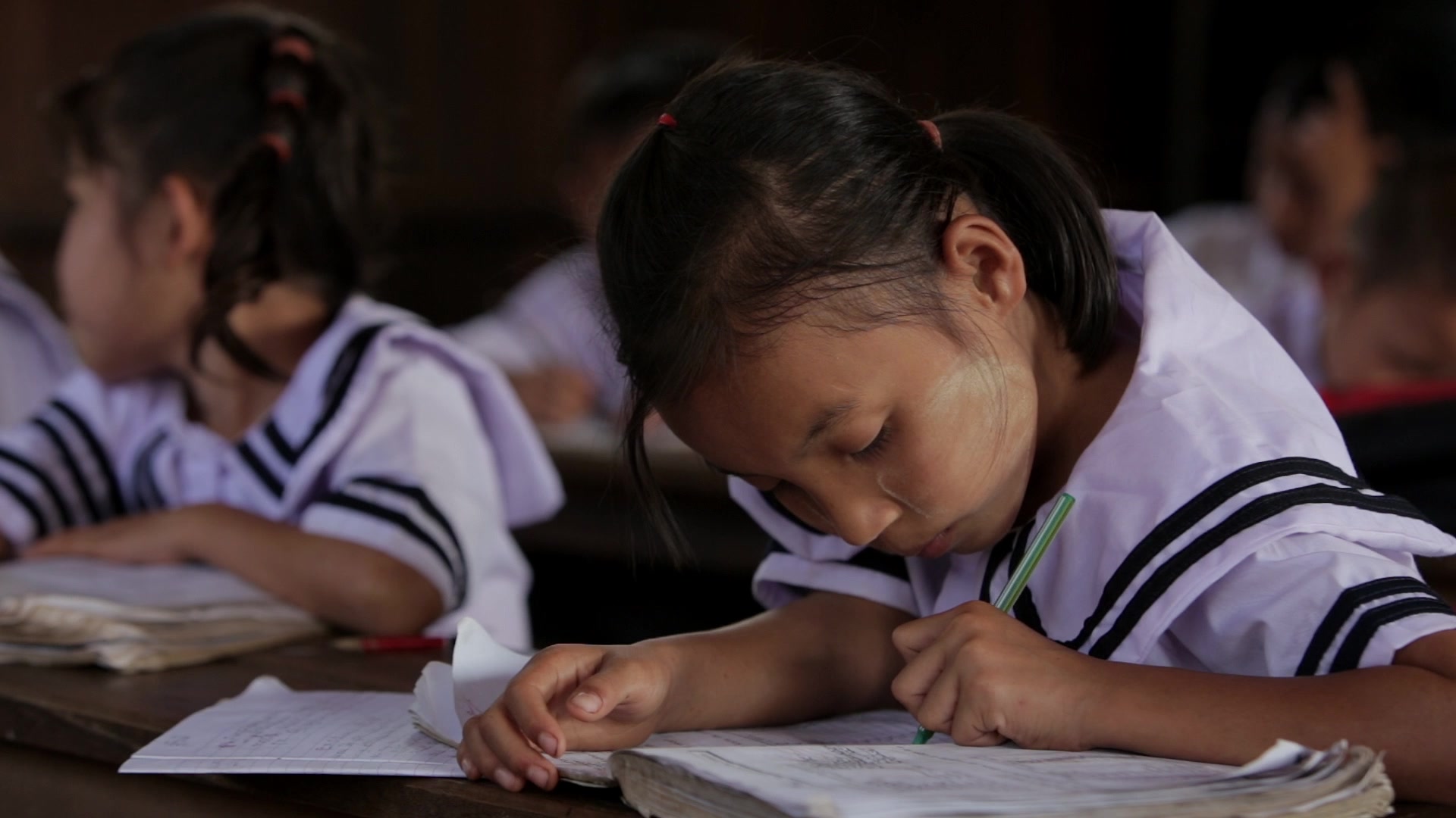 Karen Student Writes at their Desk