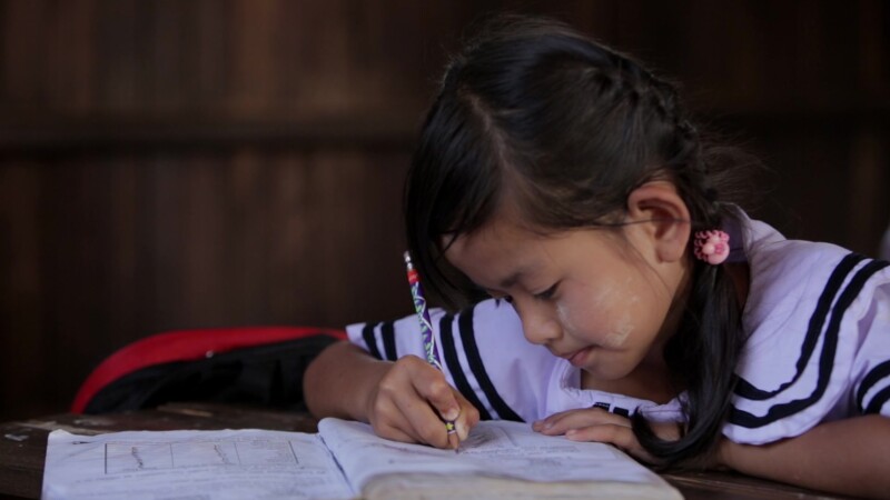Karen Student Writes at their Desk — Student of the Karen Ethnic goroup Writes at their Desk at their school in MyanmarKeywords: Burma, Child, Children, Kare...