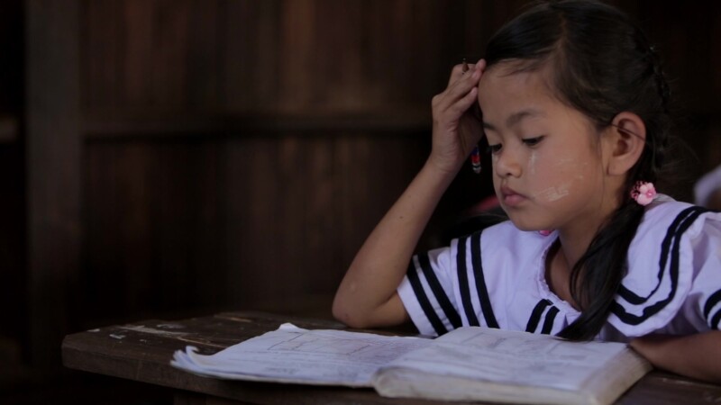 Karen Student Writes at their Desk — Student of the Karen Ethnic goroup Writes at their Desk at their school in MyanmarKeywords: Burma, Child, Children, Kare...