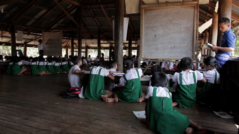 Learning at a Temporary School — With no school in the village, students learn at a temporary classroom at the Village Buddhist PagodaKeywords: Burma, Child,...
