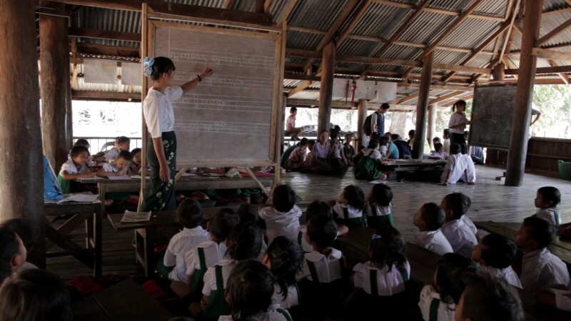 Learning at a Temporary School — With no school in the village, students learn at a temporary classroom at the Village Buddhist PagodaKeywords: Burma, Child,...
