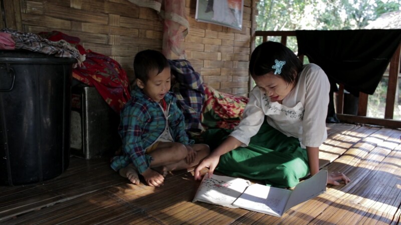 Doing Homework in Rural Myanmar — Young girls does homework on the front porch of her Bamboo home in MyanmarKeywords: Burma, Karen, Karen State, Myanmar, jun...