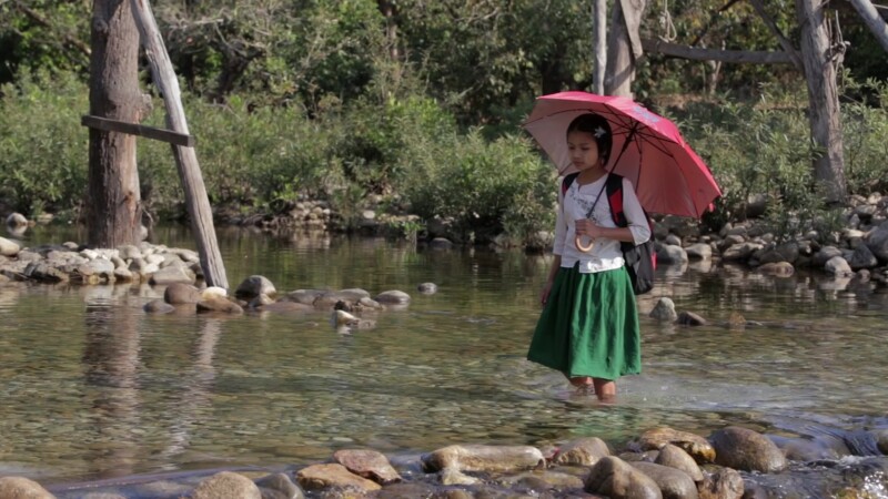 Walking to School in Myanmar — Young girl in Myanmar crosses mountain stream on her way to school. — Burma, Karen, Karen State, Myanmar, jungle