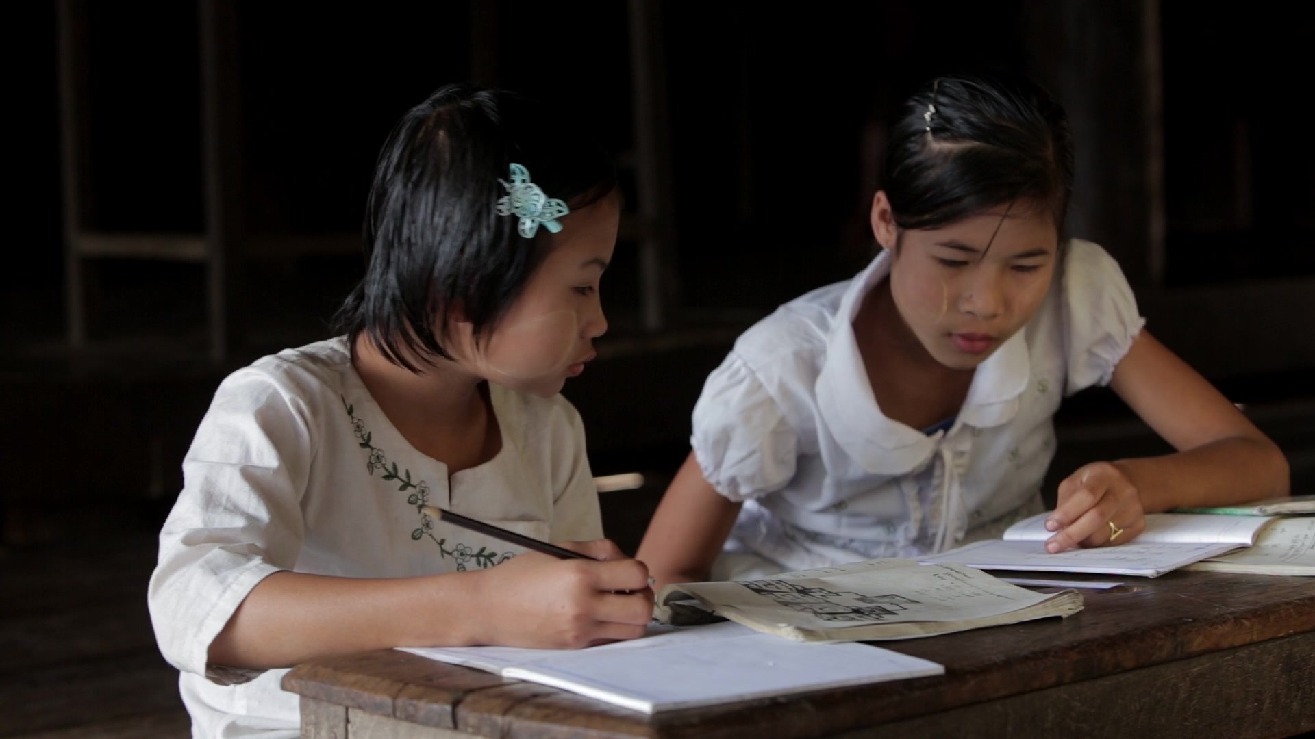Two Young Girls Work at their Desk