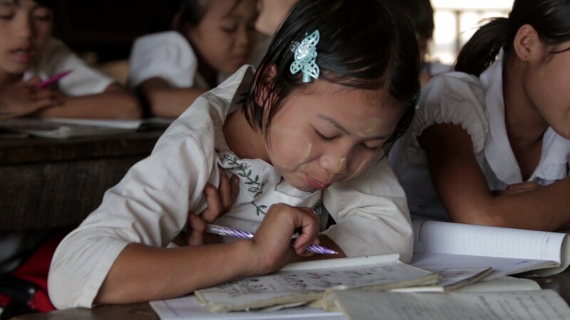 Karen Students in School — Cute Karen girls at their desk in a temporary classroom in rural Myanmar. — Burma, Child, Children, Karen, Karen State