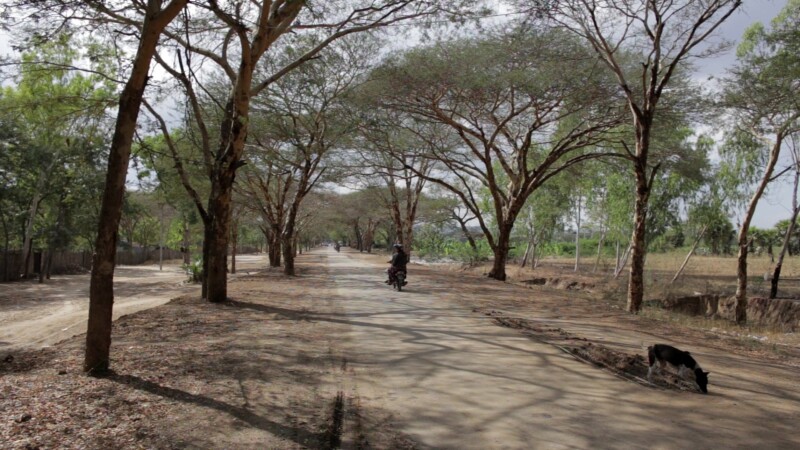 Myanmar 2014 2245725 V1 0104 — Traffic on a Dirt Road in Rural MyanmarKeywords: Rural, Myanmar, Burma, Road, moter bike