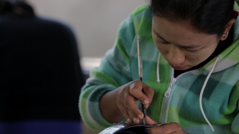 Closeup Of Lacquerware Etching — Burmese woman works at a crafts shop in Bagan Etching intricate designs on Lacquerware, for sale to tourists who visit the r...