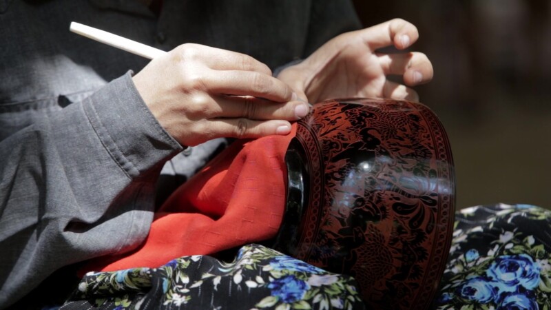 Closeup Of Lacquerware Etching — Burmese woman works at a crafts shop in Bagan Etching intricate designs on Lacquerware, for sale to tourists who visit the r...