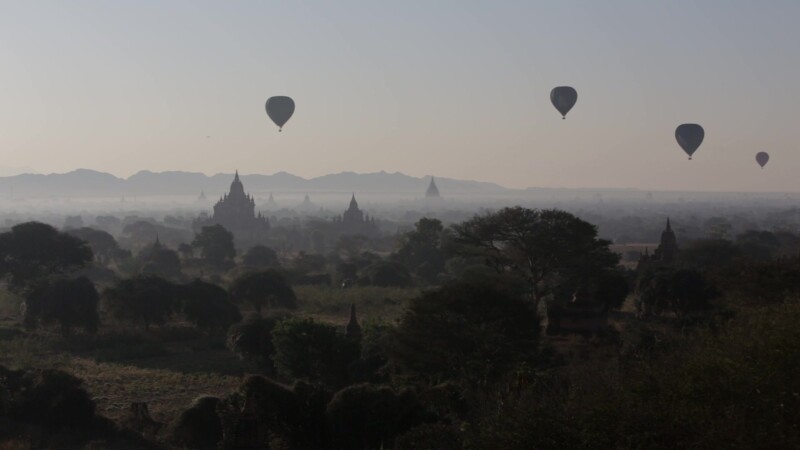Up Up and Away! — Hot air Balloons drift over the ancient Buddhist pagodas of Bagan, Burma, in the early morning light. — Ancient, Archaeology, Bagan, Balloo...