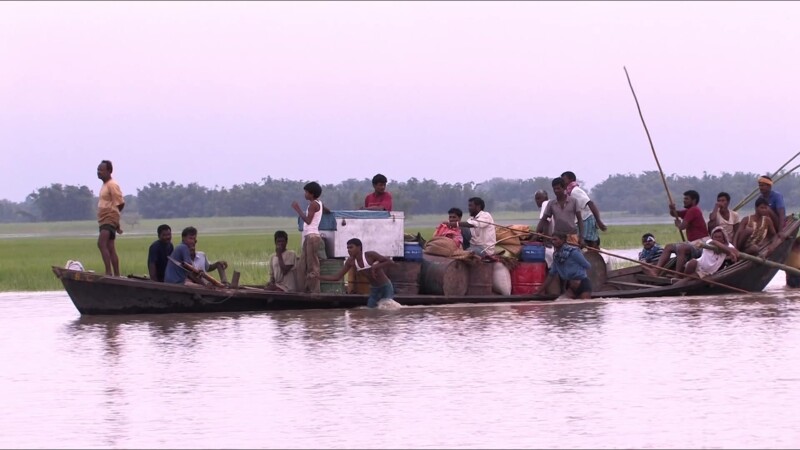 Rescued from Floods — After a dam breaks in Southern Nepal, People displaced from their homes and farms are brought to safety in boats. — Nepal, IDP, Interna...