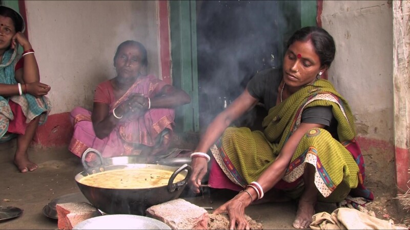 Emergency Food — People displaced by flooding cook food they have received from an emergency distribution. — Nepal, IDP, Internally Displaced