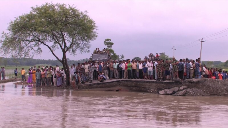 Cut Off From Services — After a dam breaks in Southern Nepal, roads are washed out, cutting people off from food supplies and emergency services — Nepal, IDP...