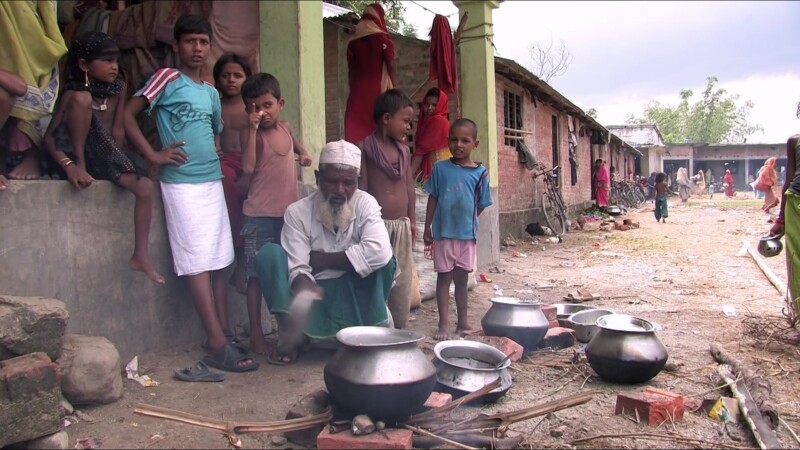 Emergency Food — People displaced by flooding cook food they have received from an emergency distribution. — Nepal, IDP, Internally Displaced
