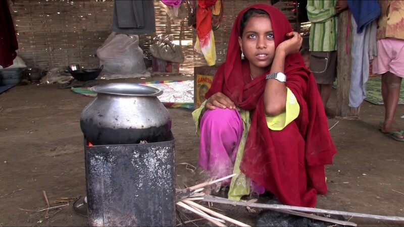 Emergency Food — People displaced by flooding cook food they have received from an emergency distribution. — Nepal, IDP, Internally Displaced