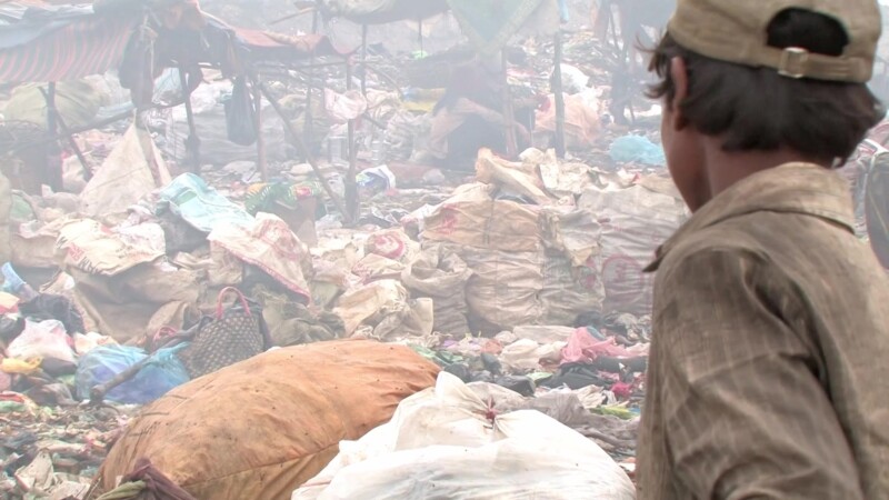 Young Boy works at a City Dump, — A child works at a city dump, looking for things to recycle — Poverty, City Dump, Scavaging, Working at the City Dump, chil...