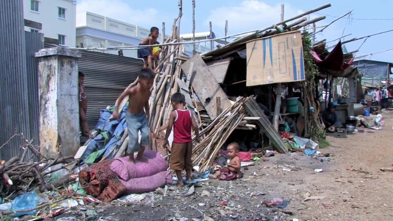 Children in Poverty — Children growing up in poverty play in the trash. — Poverty, Shantytown, slum, squatter Settlement, children